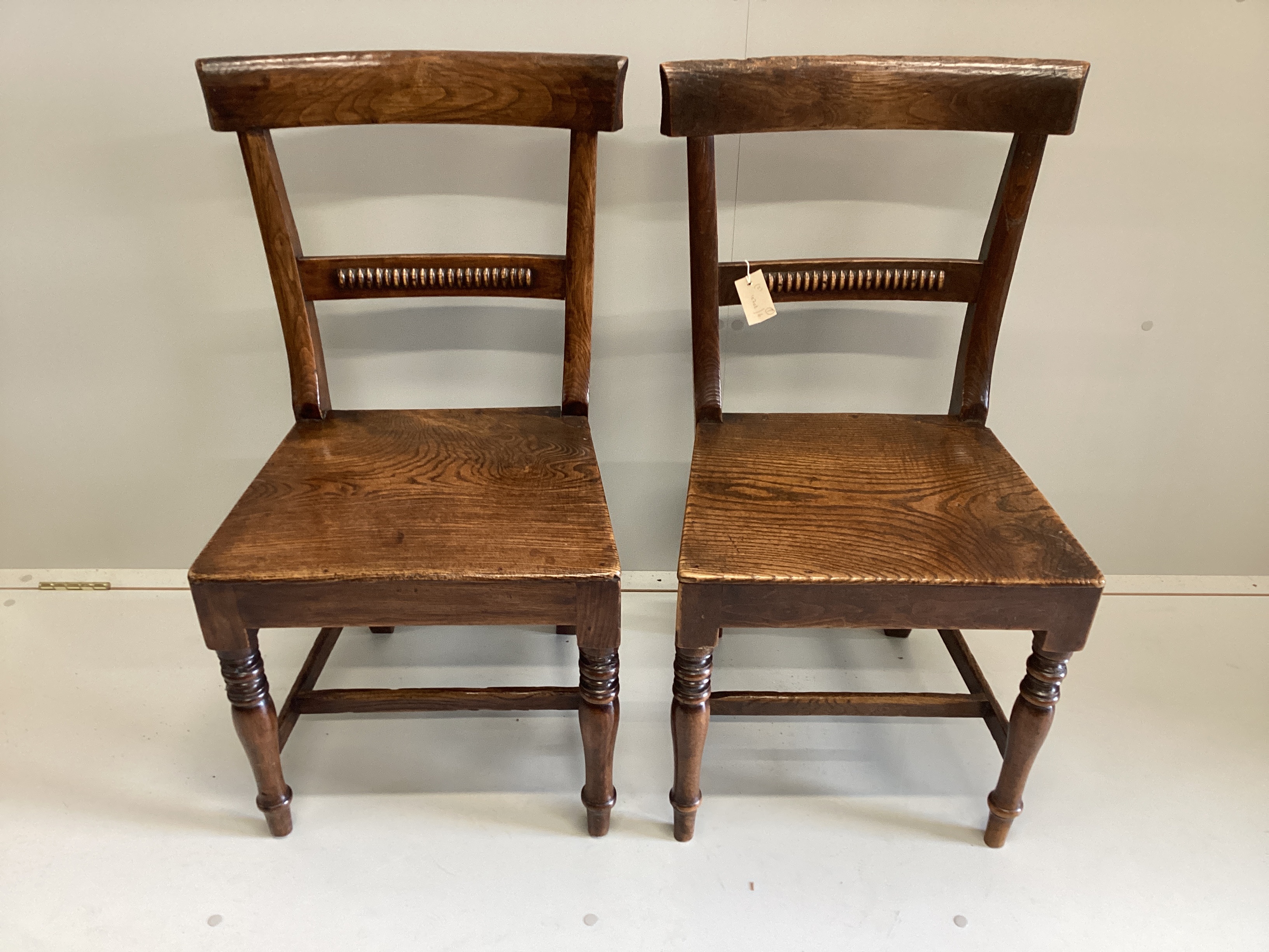 A pair of Regency provincial elm wood seat dining chairs, width 44cm, depth 36cm, height 86cm